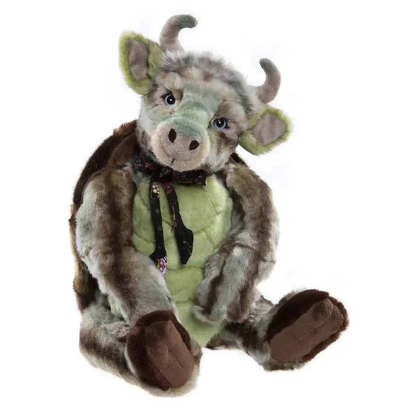 Charlie bears mock turtle - a stuffed toy resembling acombination between a cow and a turtle with green and brown collors wearing a black floral tie