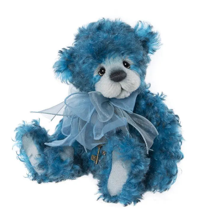 Charlie Bears Narnia = A blue teddy bear wearing a blue scarf around neck and a necklace with a key charm
