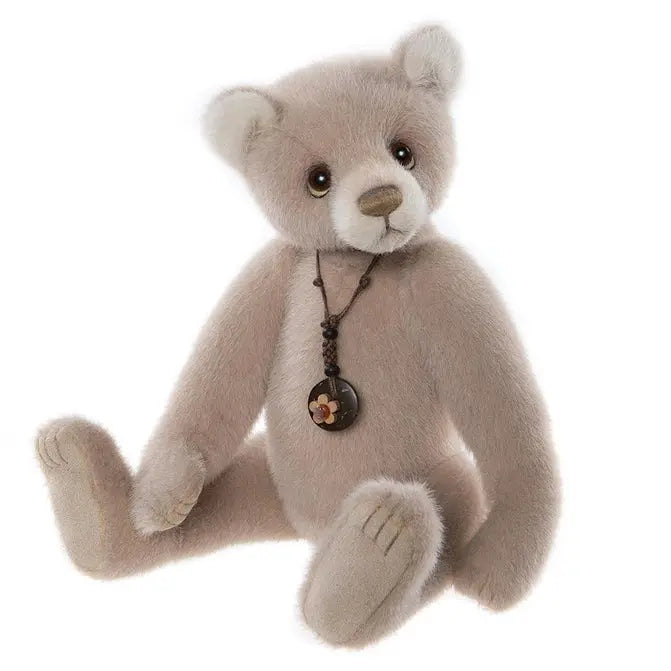 Charlie Bears Tall Tales - a classic brown teddy bear wearing a black leather necklace with a little floral charm

