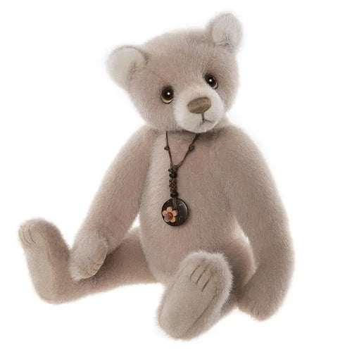 Charlie Bears Tall Tales - a classic brown teddy bear wearing a black leather necklace with a little floral charm
