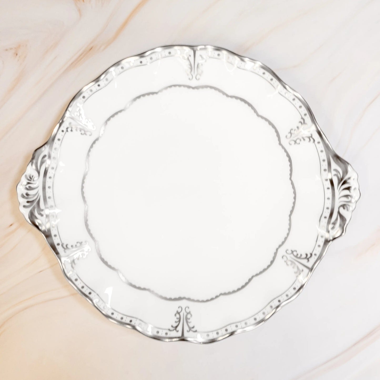 Silver decorative plate on a marble surface