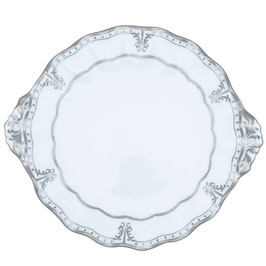 Decorative white plate with intricate patterns on a white background