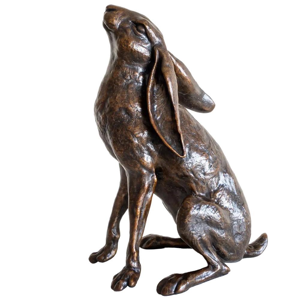 Bronze statue of a rabbit on a white background