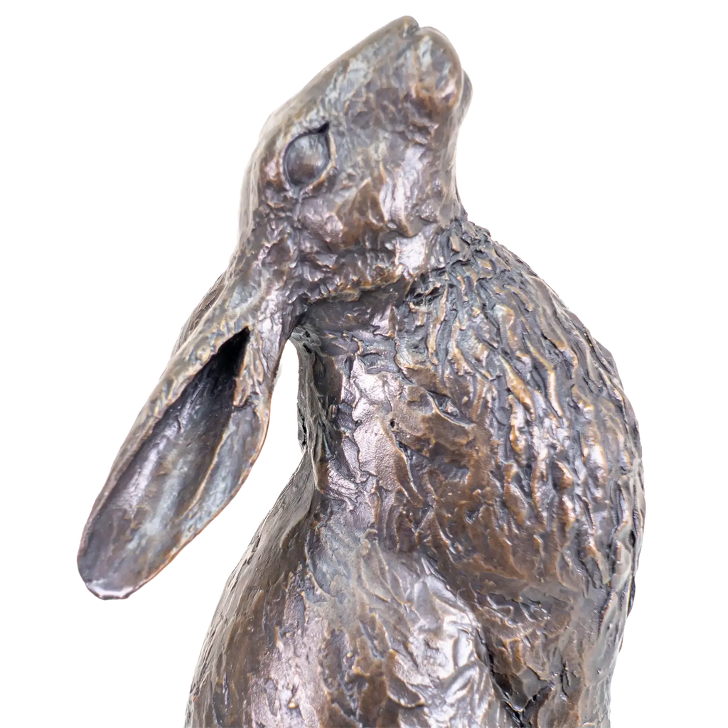 Bronze sculpture of a rabbit on a white background