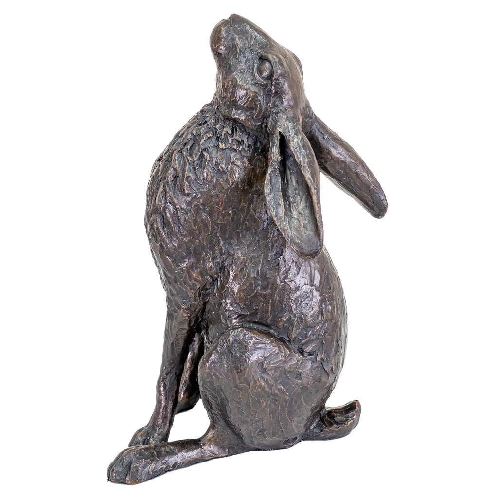 Bronze statue of a rabbit on a white background