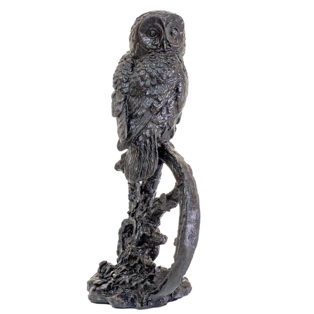 Statue of an owl perched on a branch against a white background
