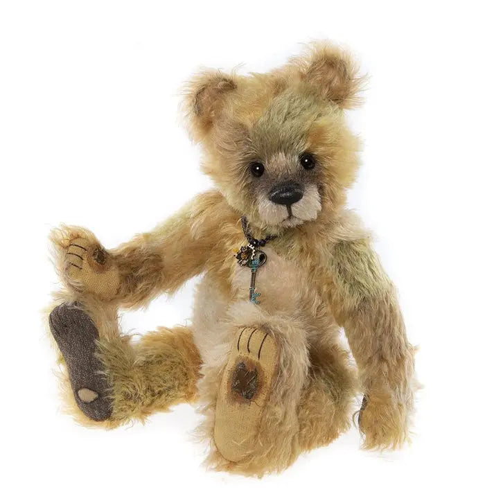 Charlie bears killyan - a brown with a greenish tint teddy bear weareing a necklace with a key and flower charm